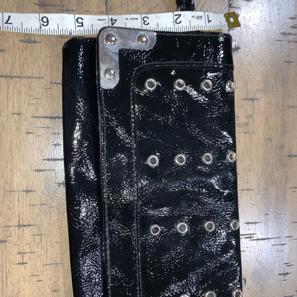 Black patent leather like clutch with grommets